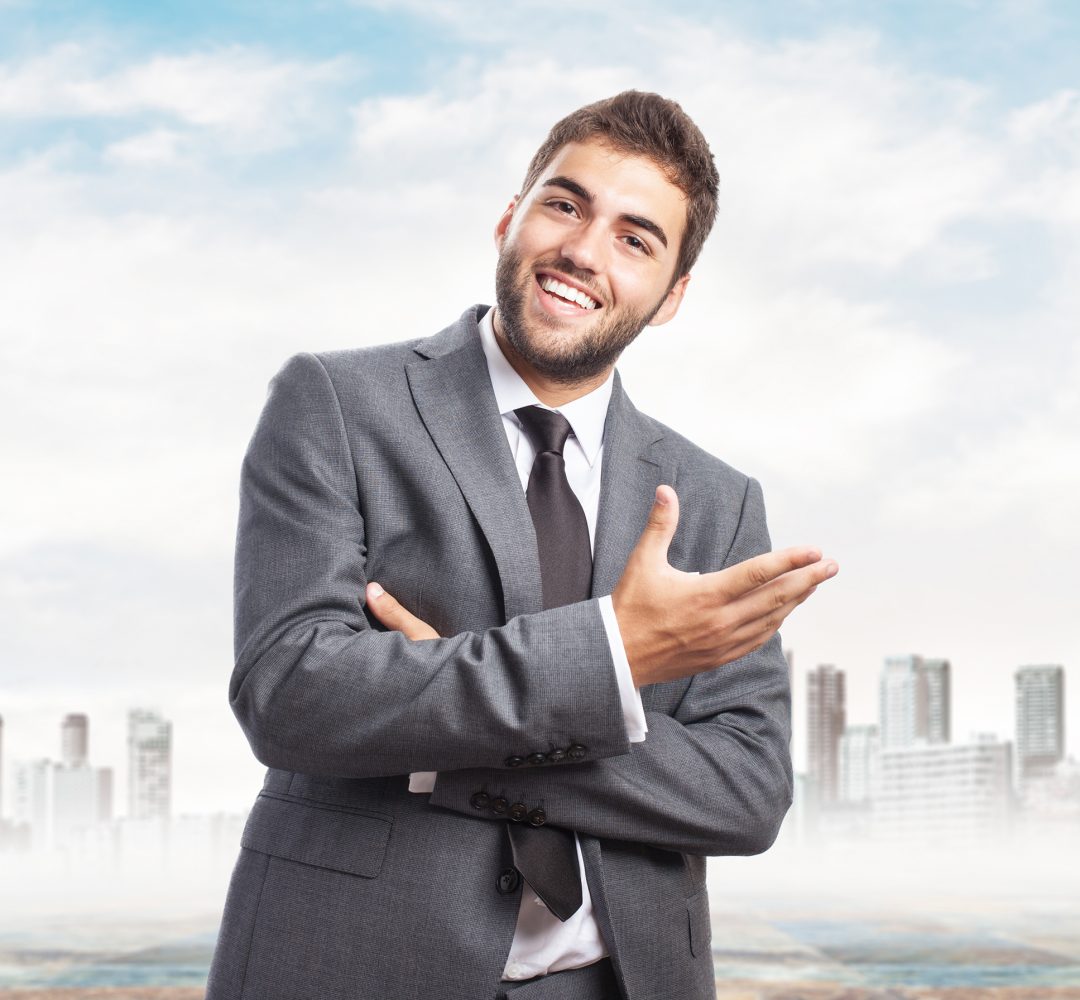 handsome young successful man doing a welcome gesture